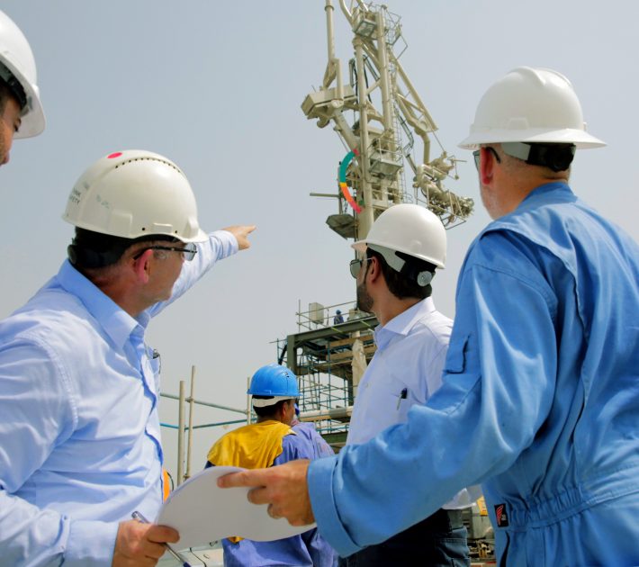 Group of men pointing at HP Gas Arm