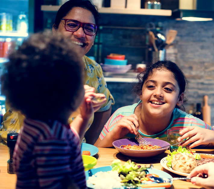 LNG providing clean energy to power home while family eats a meal