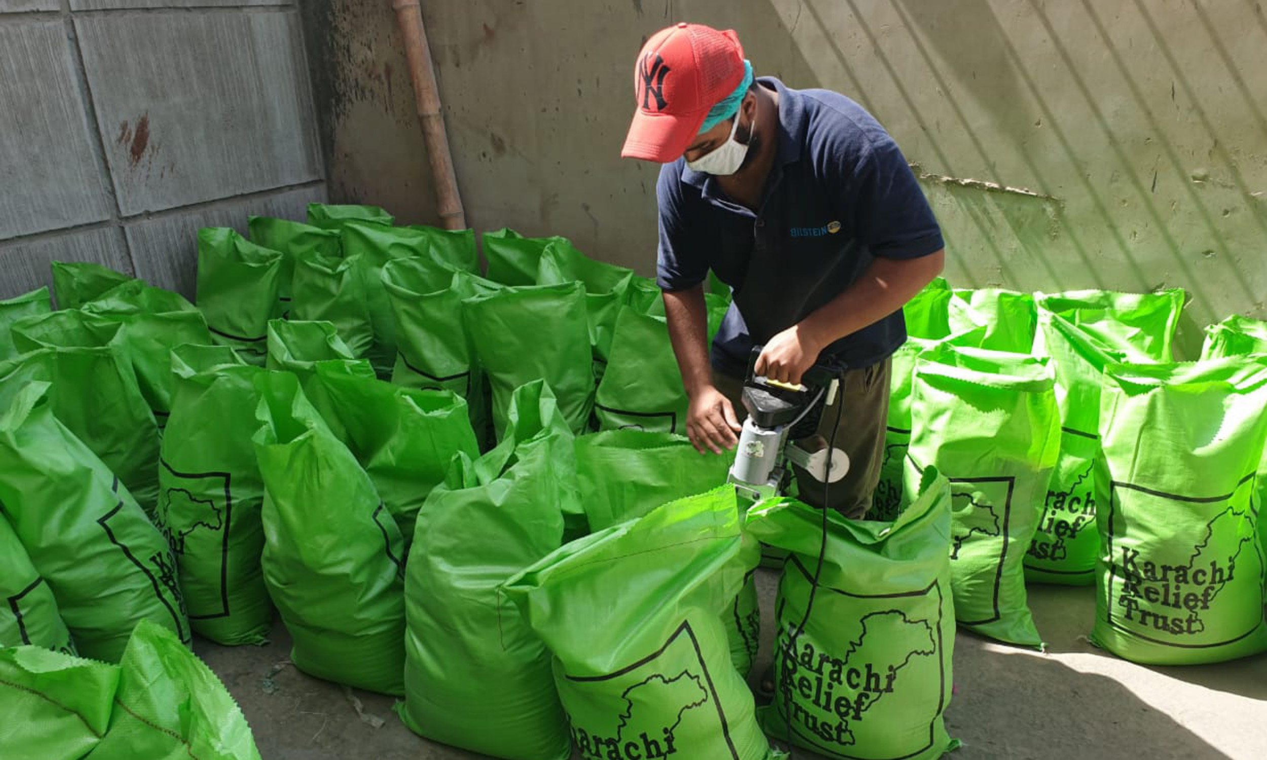 Worker packing donations for COVID-19 food relief